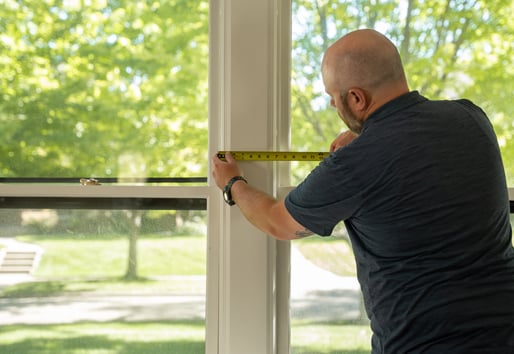 Contractor measuring a window