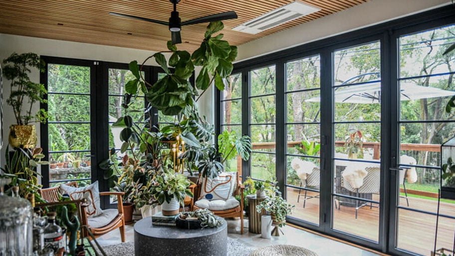 interior view of enclosed patio with large windows looking outdoors