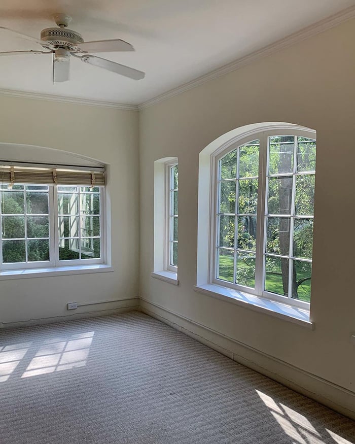 sunroom before remodeling with old windows and old carpeting.
