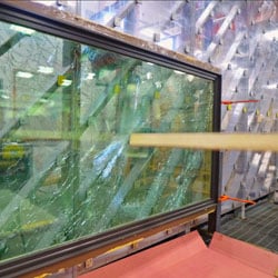 testing being done on window with board penetrating glass
