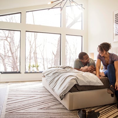 livingroom with fullview black framed andersen windows looking out to pool