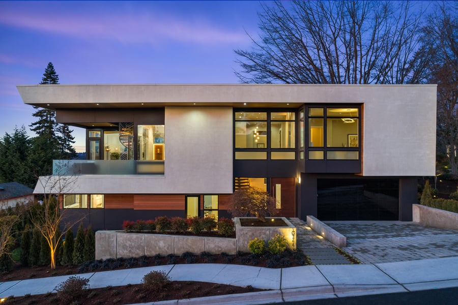 The front facade of a Mid-Century Modern home with a flat roof, a balcony on the second floor, and E-Series Casement, Awning, and Picture windows with black exteriors.