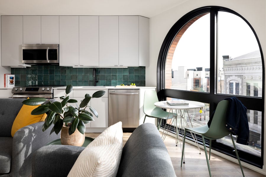 An apartment with a large arched window combination unit made of Andersen® E-Series Specialty Windows.